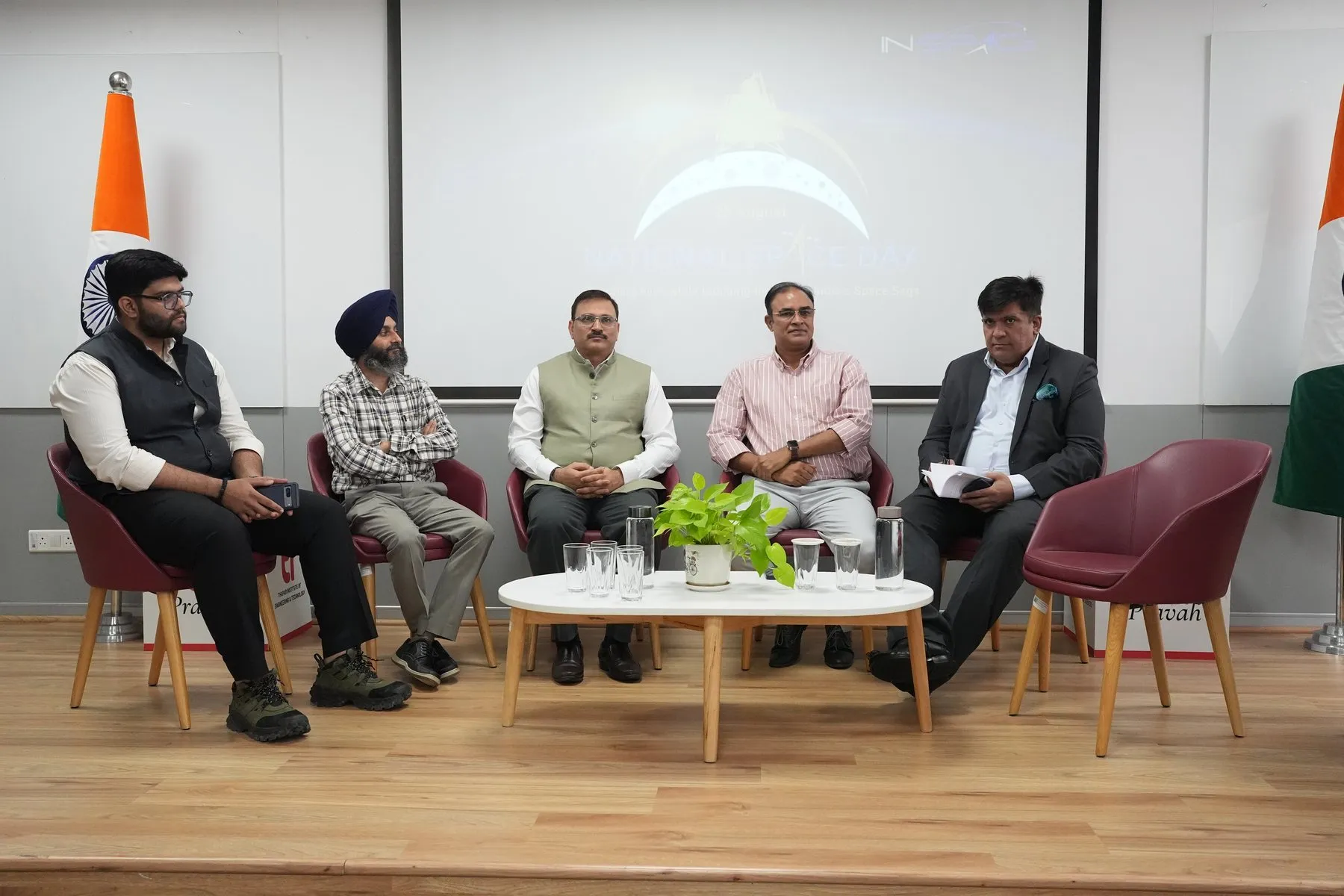 A panel discussion at the IN-SPACe National Space Day programme, Thapar Institute of Engineering and Technology, Patiala. Five panellists are seated before a screen reading “23 August · National Space Day”, with the IN-SPACe mark above it; Rajeev Tomer is at the right of the panel.